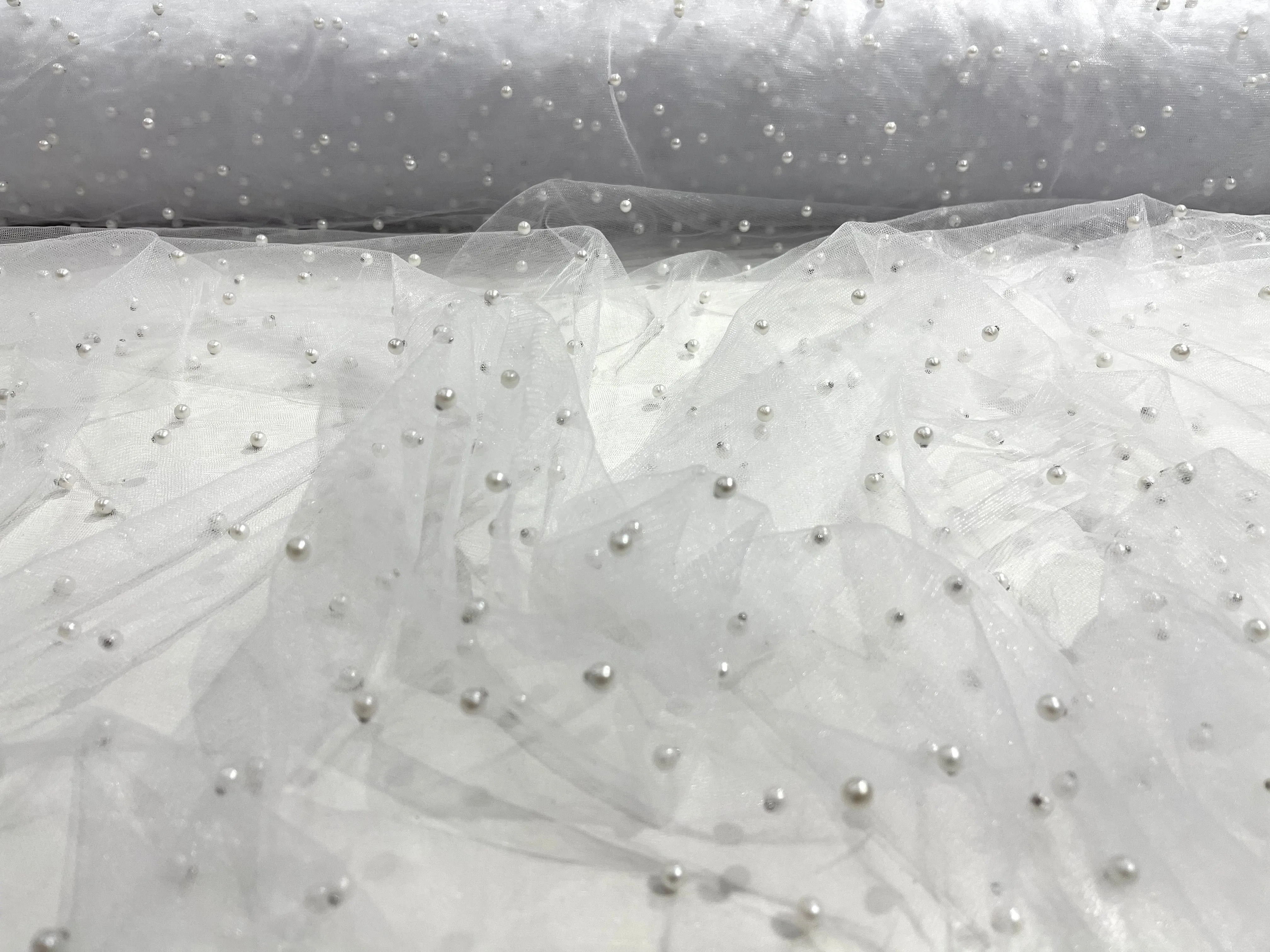 Off White Scattered Pearls Studded Mesh, 2-Way Stretch, sold by the yard.